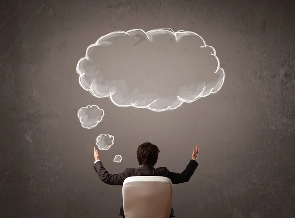 Businessman sitting with cloud thought above his head — Stock Photo, Image