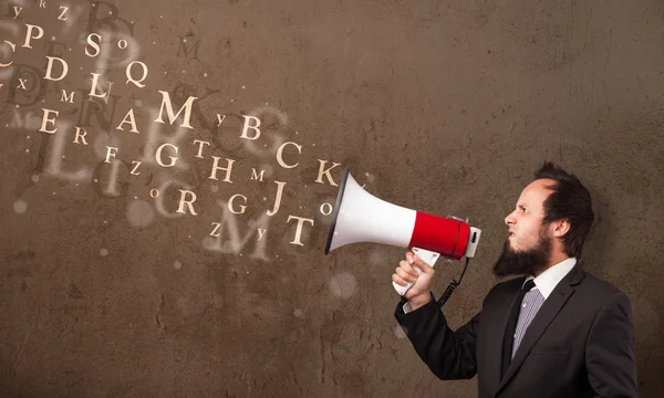 Man in shirt shouting into megaphone and text come out — Stock Photo, Image