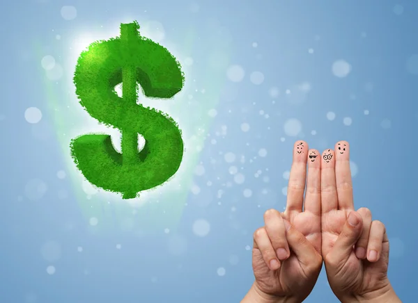 Happy smiley fingers looking at green leaf dollar sign — Stock Photo, Image