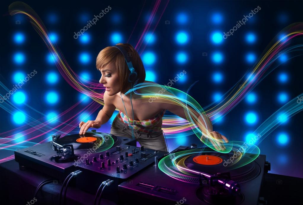 Young Dj girl mixing records with colorful lights Stock Photo by ©ra2studio  49618455
