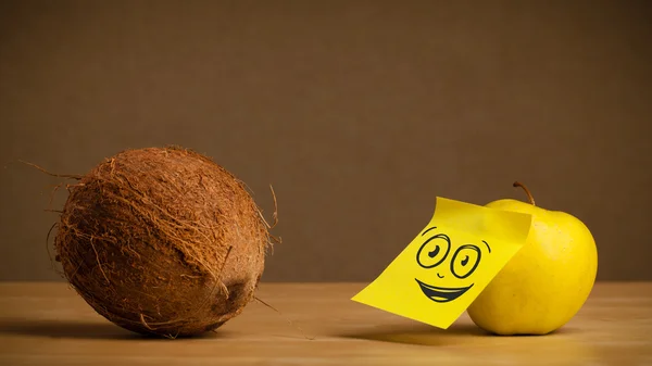 Apple with post-it note watching at coconut — Stock Photo, Image