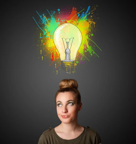 Young woman thinking with lightbulb above her head — Stock Photo, Image