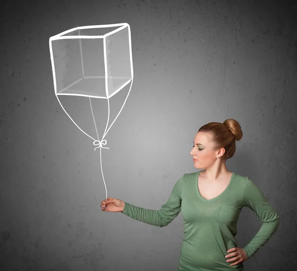 Vrouw met een kubus ballon — Stockfoto