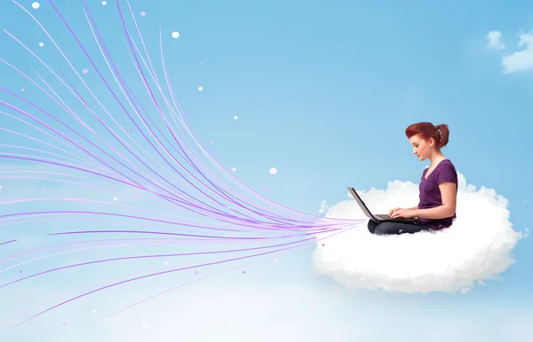 Young woman sitting in cloud with laptop — Stock Photo, Image