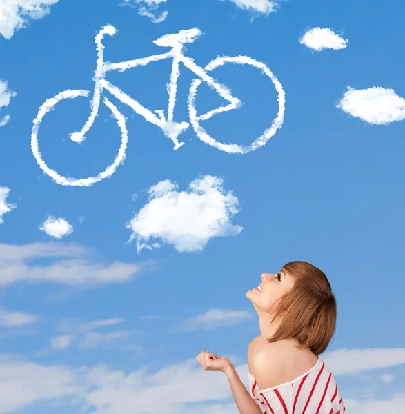 Young girl looking at bicycle clouds on blue sky