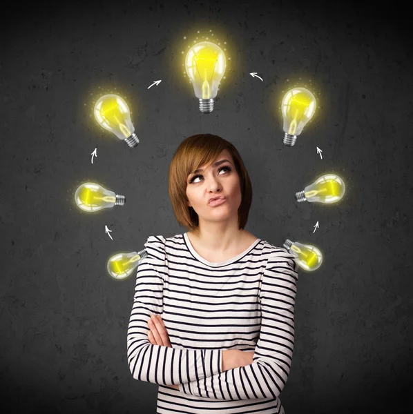 Young woman thinking with lightbulb circulation around her head — Stock Photo, Image