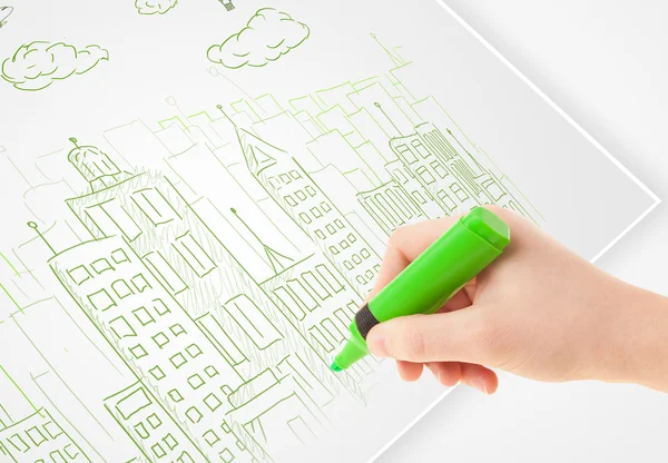 A person drawing sketch of a city with balloons and clouds on a — Stock Photo, Image