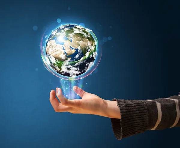 Woman holding a glowing earth globe — Stock Photo, Image