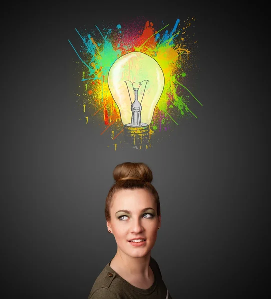 Young woman thinking with lightbulb above her head — Stock Photo, Image