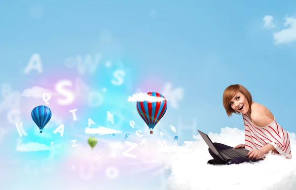 Young woman sitting in cloud with laptop — Stock Photo, Image