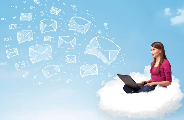 Young woman sitting in cloud with laptop — Stock Photo, Image