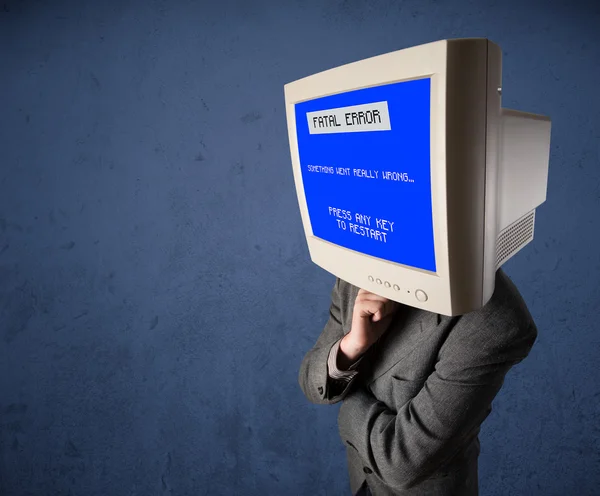 Person with a monitor head and fatal error blue screen on the di — Stock Photo, Image