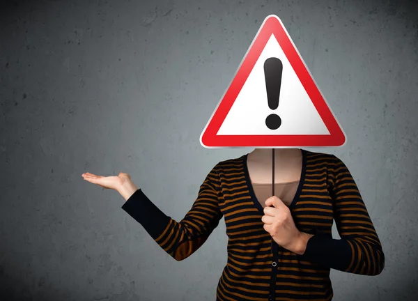 Young woman holding an exclamation road sign — Stock Photo, Image