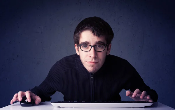 Hacker working with keyboard on blue background — Stock Photo, Image