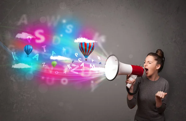 Girl shouting into megaphone and abstract text and balloons come — Stock Photo, Image