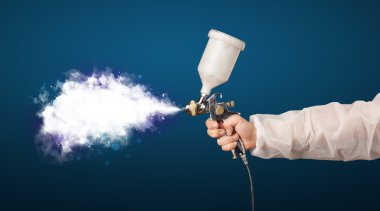 Painter with airbrush gun and white magical smoke  clipart