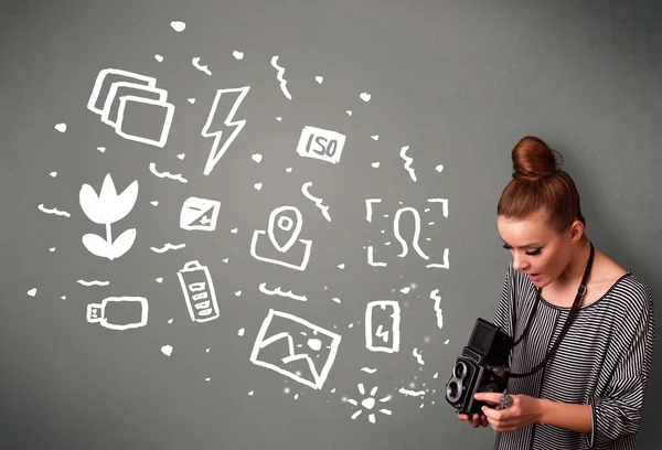Photographer girl capturing white photography icons and symbols — Stock Photo, Image