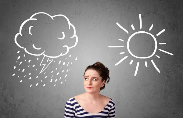 Woman standing between a sun and a rain drawing — Stock Photo, Image