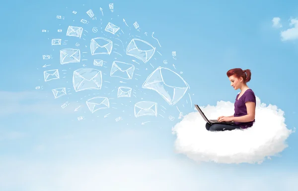 Young woman sitting in cloud with laptop — Stock Photo, Image