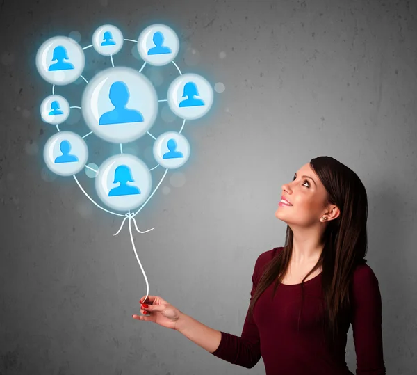 Woman holding social network balloon — Stock Photo, Image