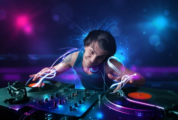 Disc jockey playing music with electro light effects and lights — Stock Photo, Image