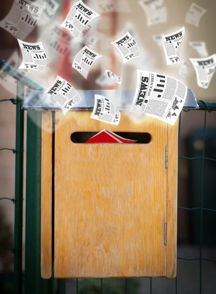 Post box with daily newspapers flying — Stock Photo, Image