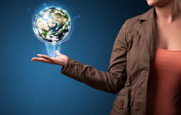 Woman holding glowing earth globe — Stock Photo, Image