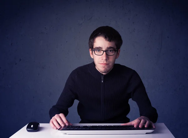 Hacker working with keyboard on blue background — Stock Photo, Image