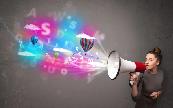 Girl shouting into megaphone and abstract text and balloons come — Stock Photo, Image