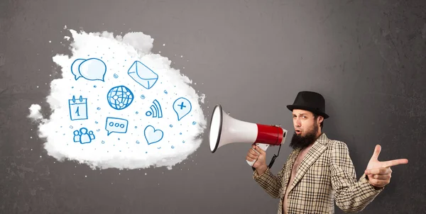 Man shouting into loudspeaker and modern blue icons and symbols — Stock Photo, Image