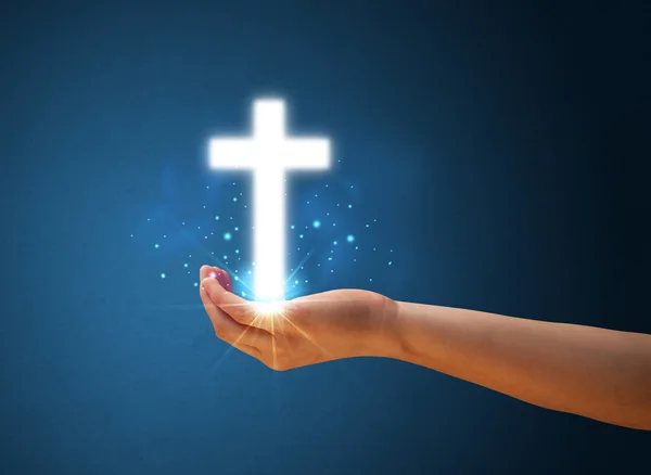 Glowing cross in the hand of a woman — Stock Photo, Image