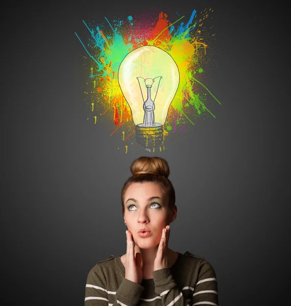 Young woman thinking with lightbulb above her head — Stock Photo, Image