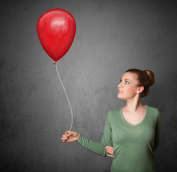 Γυναίκα που κρατά ένα κόκκινο μπαλόνι — Φωτογραφία Αρχείου