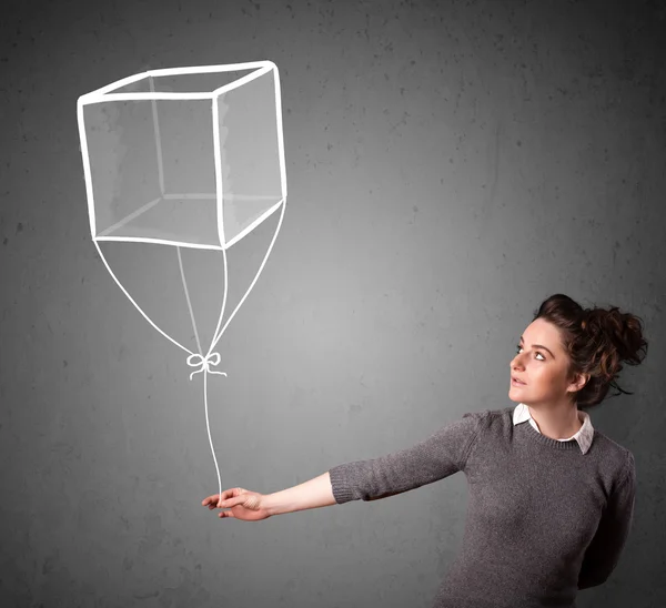 Vrouw met een kubus ballon — Stockfoto