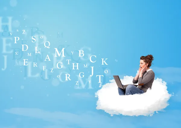 Young woman sitting in cloud with laptop — Stock Photo, Image