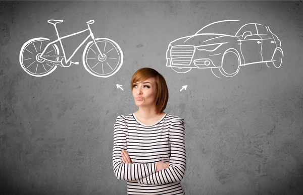 Woman making a choice between bicycle and car — Stock Photo, Image