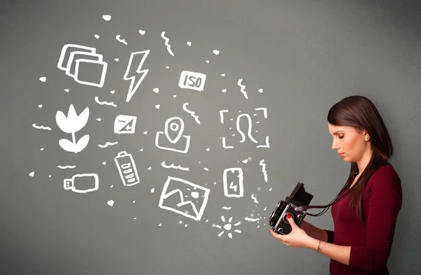 Photographer girl capturing white photography icons and symbols — Stock Photo, Image