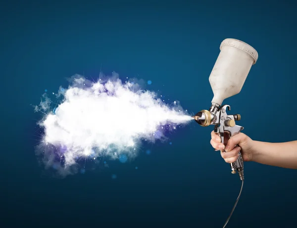 Schilder met airbrush pistool en witte magische rook — Stockfoto