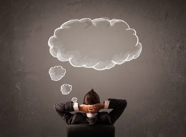 Businessman sitting with cloud thought above his head — Stock Photo, Image