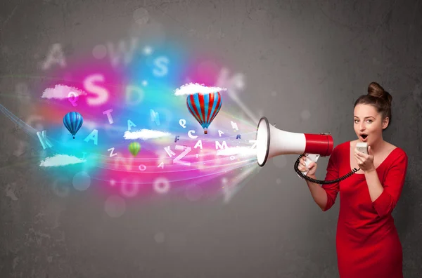 Girl shouting into megaphone and abstract text and balloons come — Stock Photo, Image