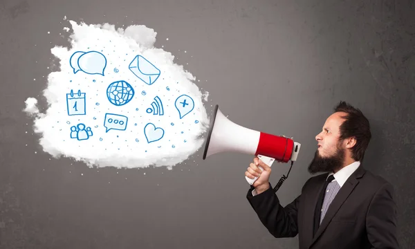 Man shouting into loudspeaker and modern blue icons and symbols — Stock Photo, Image