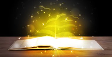 Altından parlak uçan kağıt sayfaları olan açık bir kitap