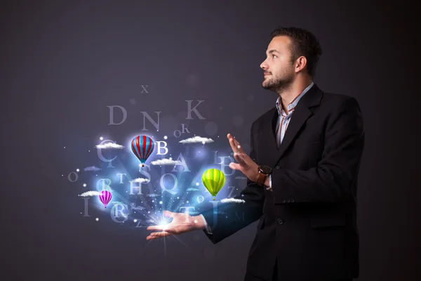 Letters and balloons in the hand of a businessman — Stock Photo, Image