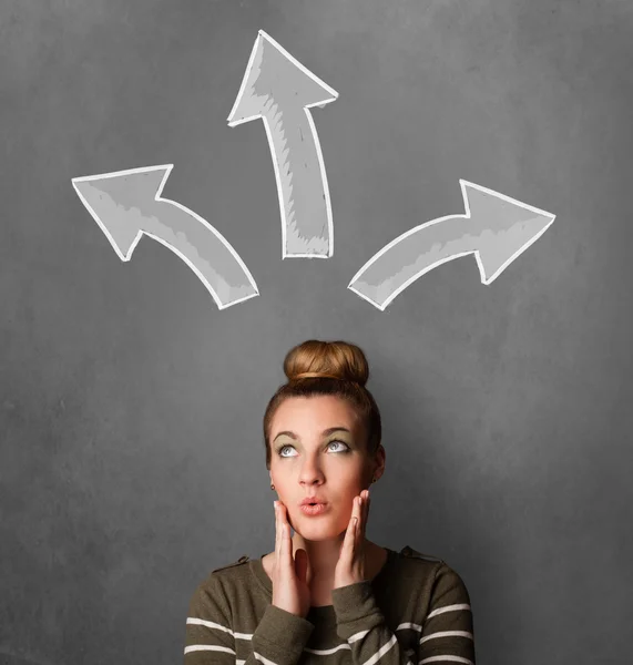 Young woman thinking with arrows above her head — Stock Photo, Image