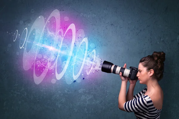 Photographer girl making photos with powerful light beam — Stok Foto