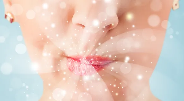 Pretty woman lips blowing abstract white lights — Stock Photo, Image