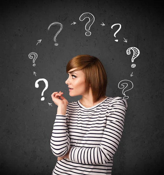 Young woman thinking with question mark circulation around her h — Stock Photo, Image