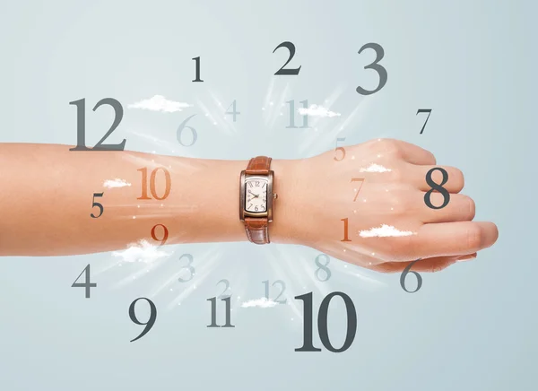 Hand with watch and numbers on the side comming out — Stock Photo, Image