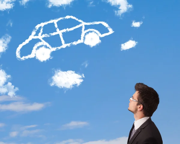 Handsome young man looking at car cloud on a blue sky — Stock Photo, Image