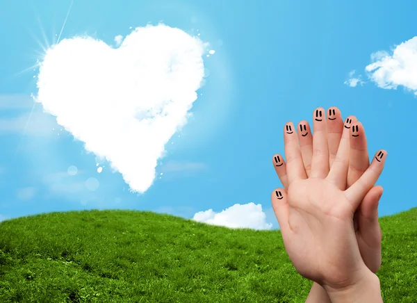 Happy smiley fingers looking at heart shaped cloud — Stock Photo, Image